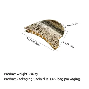 Minimalist gold metal hair claw clip with vertical brushed texture for half-up hairstyles