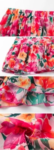 Macro shot of tiered ruffles with vibrant floral print and pink overlock stitching