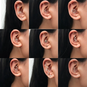 Detail view of gold-plated ear climbers with sparkling zircon and star motifs