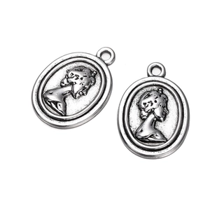 Detailed view of vintage silver alloy cameo pendants featuring classical side portraits