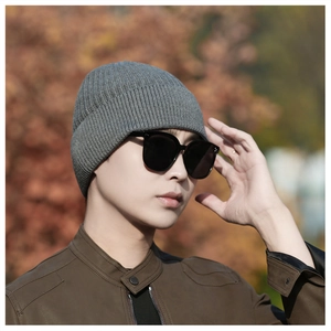 Close-up of thick dark grey ribbed knit beanie with folded cuff for winter outdoor warmth