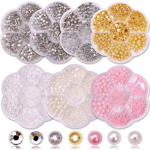 Close-up detail of assorted nail art rhinestones and pearls in seven luxury cases
