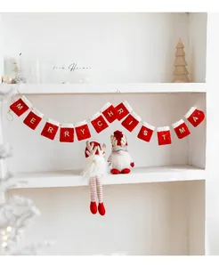 Detail of red Merry Christmas felt banner with plush trim and cute gnome figurines