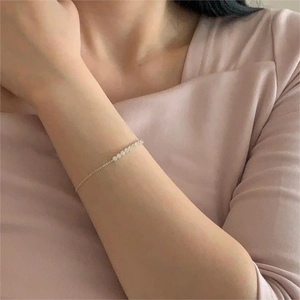 Detail of minimalist S925 sterling silver bracelet with sparkling zircon geometric charms