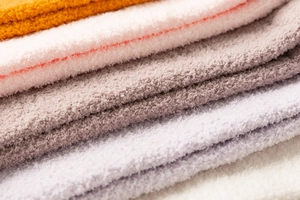 Close-up of thick coral fleece fabric showing soft texture in multiple pastel colors