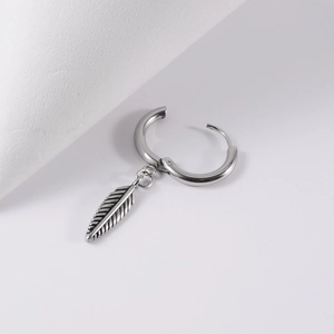 Detailed close-up of a silver stainless steel hoop earring with a vintage feather pendant