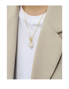 Detailed view of Baroque pearl pendant on golden rectangle link chain with toggle clasp