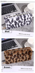 Close-up of fluffy faux fur leopard print pouches with gold zippers in blue and brown colors