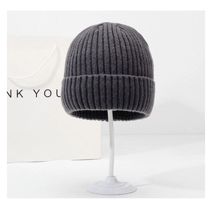 Détail du bonnet en maille gris foncé avec texture côtelée et large bord à revers hiver