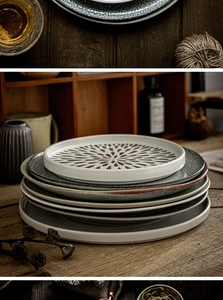Macro detail of stacked ceramic steak plates with assorted glazes on a rustic wood table