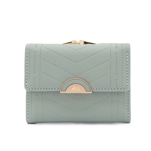 Close-up of light green PU leather wallet with diamond quilting and gold leaf buckle