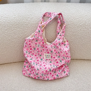 Detail of pink tulip embossed fabric on tote bag with unique floral relief texture