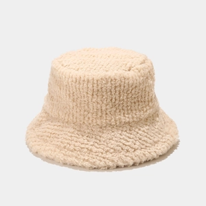 Close-up of thick beige faux shearling fabric texture on a winter bucket hat