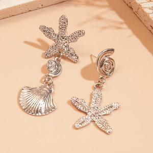 Asymmetric silver sea star and shell drop earrings with metallic texture and ocean motifs