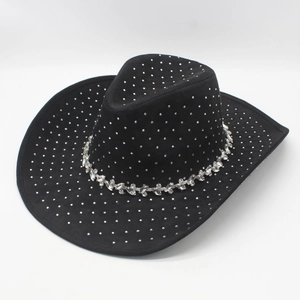 Macro detail of black cowboy hat featuring decorative silver rhinestones and wide brim
