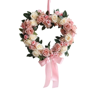 Romantic heart-shaped artificial rose wreath with pink and white flowers and satin ribbons