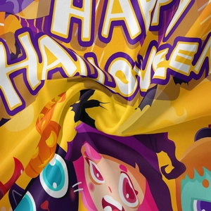 Close-up of soft fabric texture featuring cartoon Halloween prints and vibrant colors