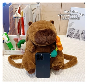 Detailed size comparison of a Capybara plush backpack with a phone on a desk