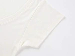 Detailed view of the V-neck and sleeve seams on a white tencel wool t-shirt