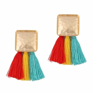 Close-up of bohemian earrings featuring hammered gold metal and vibrant tri-color silk tassels