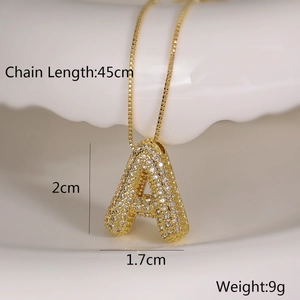 Detail view of gold letter A pendant with zircon inlay and product dimensions