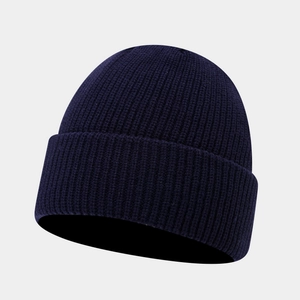 Detail of navy blue ribbed knit beanie featuring a thick cuffed edge for winter warmth