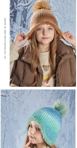 Detailed close-up of child winter knit hats with fluffy pom-poms and warm fleece lining