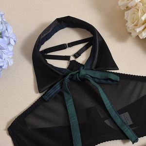 Detail of sheer black mesh halter top with green plaid ribbon bow and shirt collar