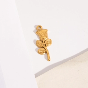 Gold rose metal pendant charm with detailed petals and leaves on a minimalist background