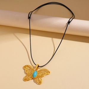 Detailed filigree butterfly pendant with turquoise stone on adjustable wax rope cord