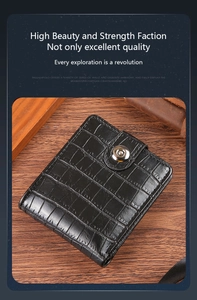 Close-up of black crocodile pattern leather wallet with a secure metal snap closure