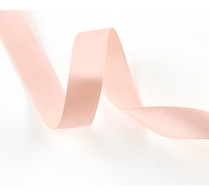 Detail showing the smooth texture and elegant drape of a 1.5cm pink satin ribbon