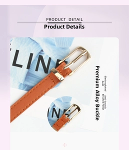 Detail of slim brown PU leather belt with brushed gold alloy buckle and fine texture
