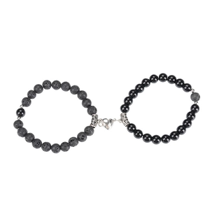Lava stone and obsidian couple bracelets with silver magnetic heart connector on white