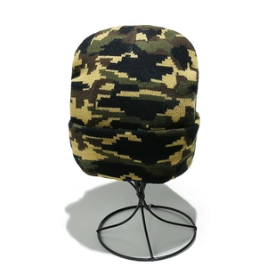 Close-up of digital camouflage knit beanie showing detailed pixel pattern and thick texture