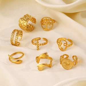 8-piece gold stainless steel ring set with tree of life, cross, and face designs
