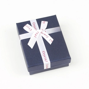 Navy blue jewelry gift box with white ribbon featuring Crystal Jewelry text
