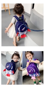 Detail of toddler rocket backpack showing safety leash and vibrant space design