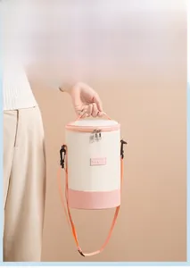 Close-up of insulated cylinder lunch bag featuring pink shoulder strap and dual zippers