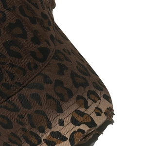 Detailed close-up of distressed brim on leopard print canvas baseball hat