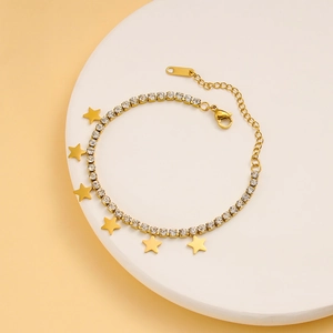 Detail of gold star bracelet featuring sparkling rhinestones and polished star charms