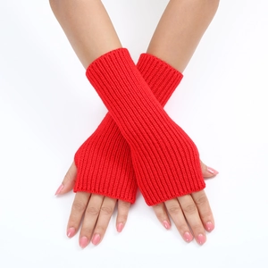 Detail of red striped knitted fingerless gloves showing ribbed texture and arm length