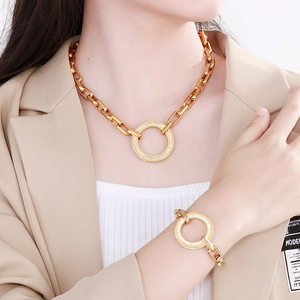 Polished gold curb chain necklace and bracelet set with round sparkling stone charms