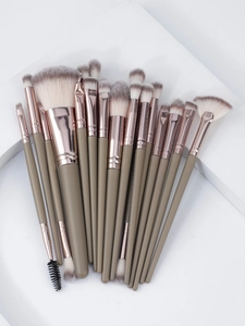 Detail shot of 20pcs professional makeup brushes with rose gold ferrules on white blocks