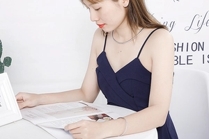 Lifestyle shot of a woman wearing a minimalist silver titanium necklace and bracelet set