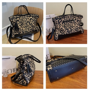 Detailed close-up of leopard print tote bag featuring black leather tassels and metallic studs