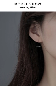 Close-up of a minimalist S999 silver T-shaped ear line hanging on a model's ear