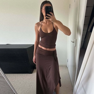 Close-up of brown halter crop top and long skirt set with slim fit and soft fabric