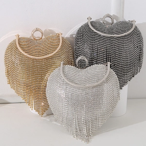 Elegant rhinestone heart evening clutches in gold, silver, and black with fringe detail
