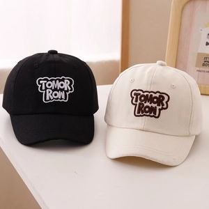 Close-up of TOMORROW 3D embroidery on black and beige cotton baseball caps